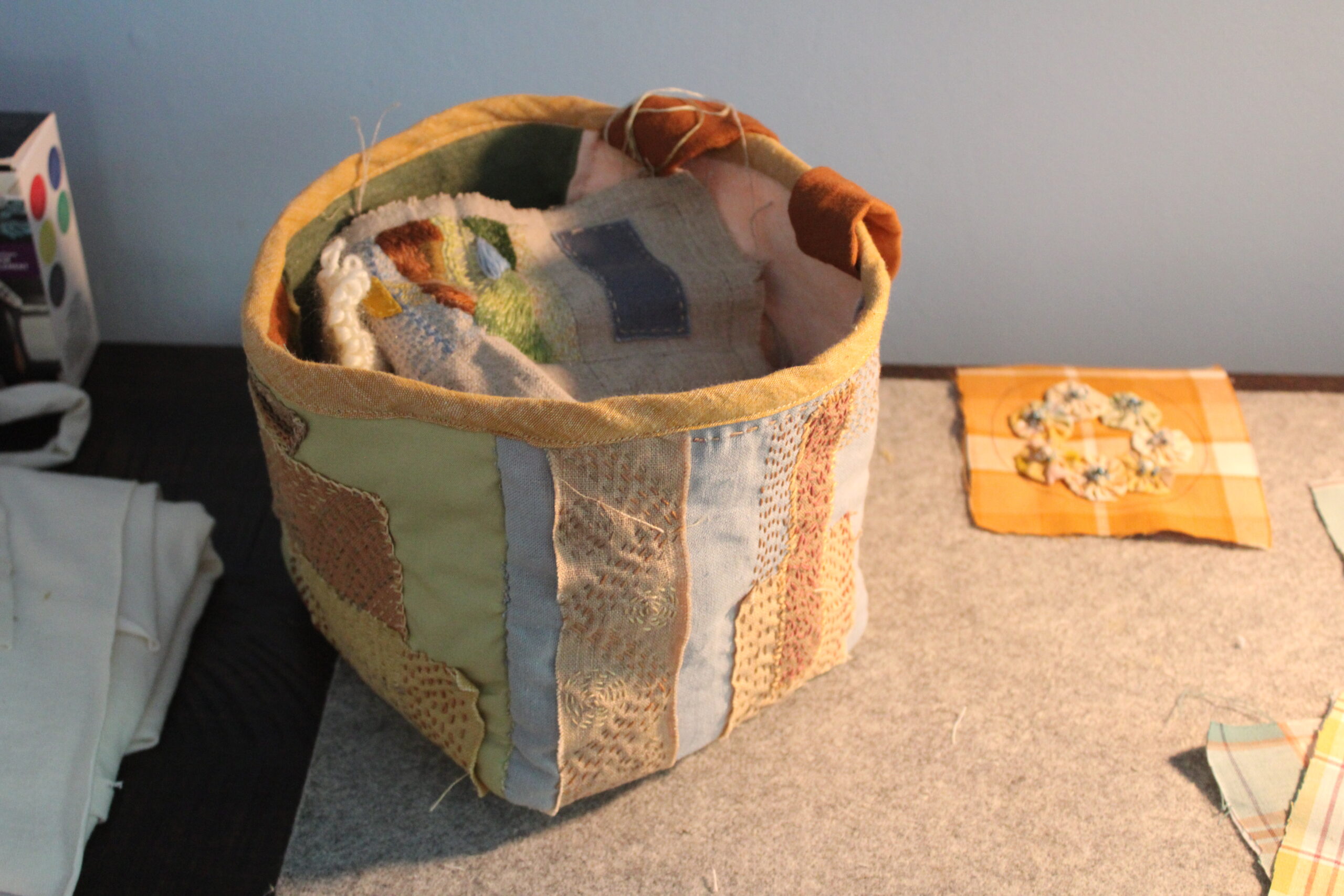 Hand sewn and embroidered rice bag sitting on a cabinet.